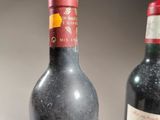 two bottles of wine sitting next to each other on a table