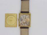 a watch that is sitting next to a watch case
