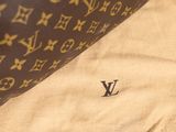 a brown and white bag with a monogram on it