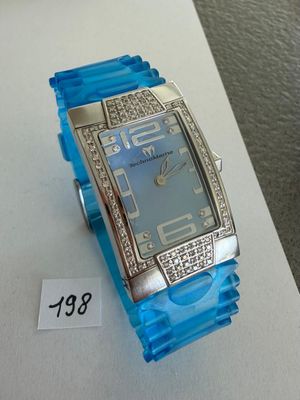 a blue watch on display on a table with a price tag