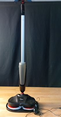 a mop that is sitting on top of a wooden table