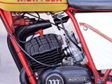 a red and yellow motorcycle parked on the side of the road