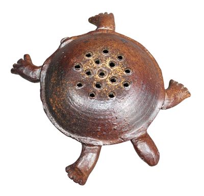 a small metal object that is sitting on a white surface