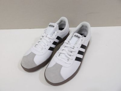 a pair of white and black sneakers on a white surface