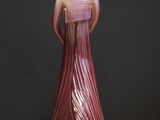a figurine of a woman in a dress on a table