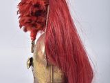 a helmet with a red wig on top of it