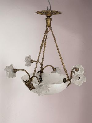 a chandelier hanging from the ceiling with flowers on it