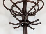 a coat rack that has a bunch of hooks attached to it