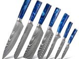 six knives are lined up in a row on a white surface