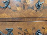 an image of a wooden chest of drawers with flowers and birds on it