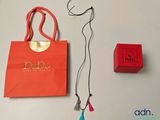 a red bag and a red necklace on a table