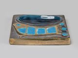 a picture of a blue and gold plate with a fish on it