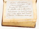 an old book with writing on it sitting on top of a table