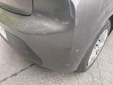 a close up of a car ' s front bumper with a denting on it
