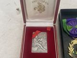 three medals and a medal in a box on a table