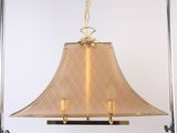 brass chandelier with a quilted shade hanging from the ceiling