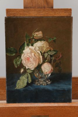 a painting of roses in a glass vase on a wooden easel
