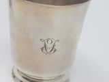 silver plated cup with a monogram on the bottom