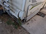 a small white rv parked on the side of the road