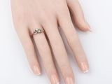 an image of a woman ' s hand with a ring on it