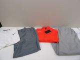 several pairs of men ' s clothing are laid out on a table