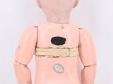 a small pink doll with a hole in it ' s chest