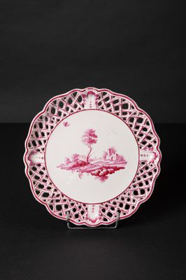 a pink and white plate with a bird on it