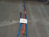 a blue and orange hose laying on the ground next to a yellow and red hose