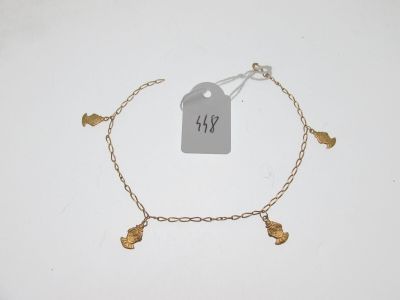 a close up of a gold bracelet with a tag on it
