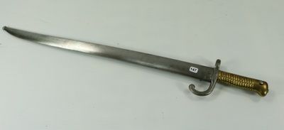 an old sword with a gold handle on a white surface