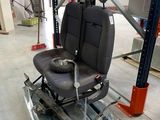 a picture of a car seat on a pallet in a warehouse