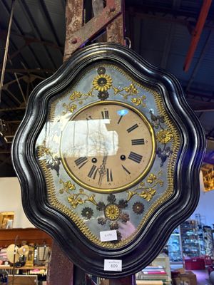 a clock that is hanging on a pole in a store