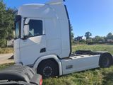 a white truck that is parked in the grass