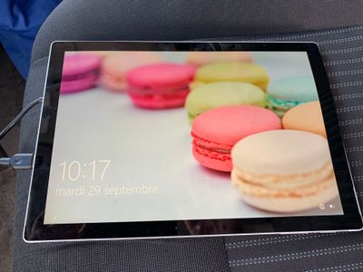 a tablet with a picture of macarons on the screen