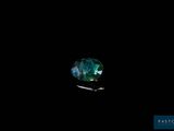 un gros plan d'un diamant vert sur fond noir