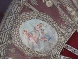 a close up of a decorative pillow with a painting on it