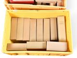 a yellow box filled with books on a white surface