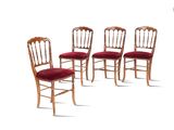 four wooden chairs with red upholstered cushions on a white background