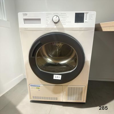 an image of a washing machine in the corner of a room