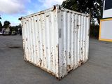 a white container sitting in the middle of a parking lot
