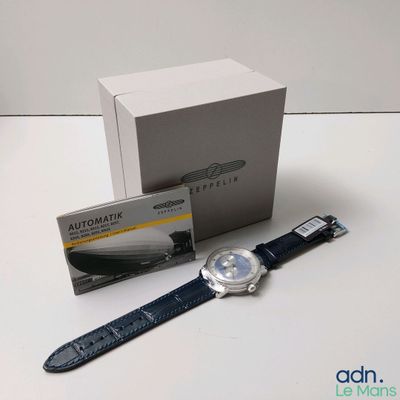 a watch that is sitting on a table next to a box