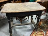 a table that is sitting in a room with many chairs