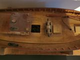 a wooden model of a boat on display in a museum