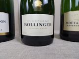 three bottles of champagne are lined up on a table