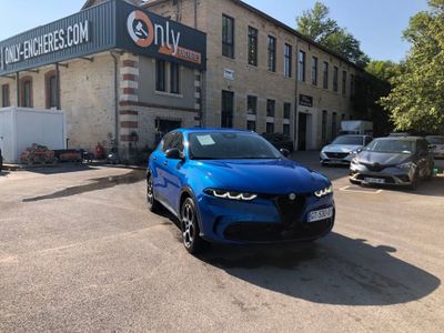 une voiture bleue garée devant un bâtiment dans un parking
