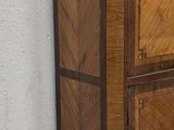 a wooden cabinet with two drawers on top of it
