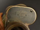a close up of a camera with a leather strap
