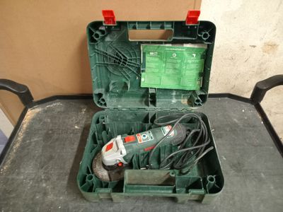 a green box with a drill and a cord in it