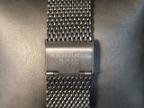 an image of a black watch with a silver band on a black case