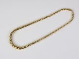 a close up of a gold chain on a white surface